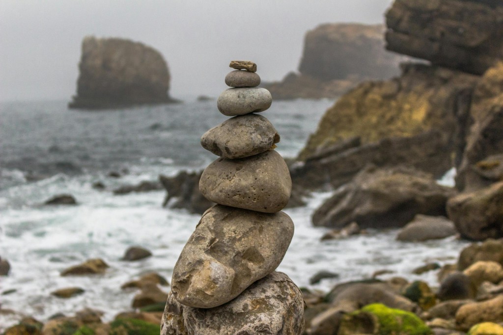 Stacked river stones representing balance and intentional capital stewardship